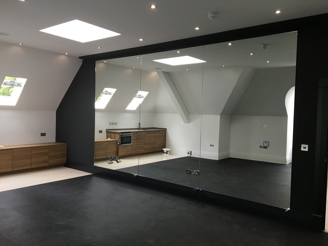 Frameless glass wall dividing loft conversion in Tufnell Park