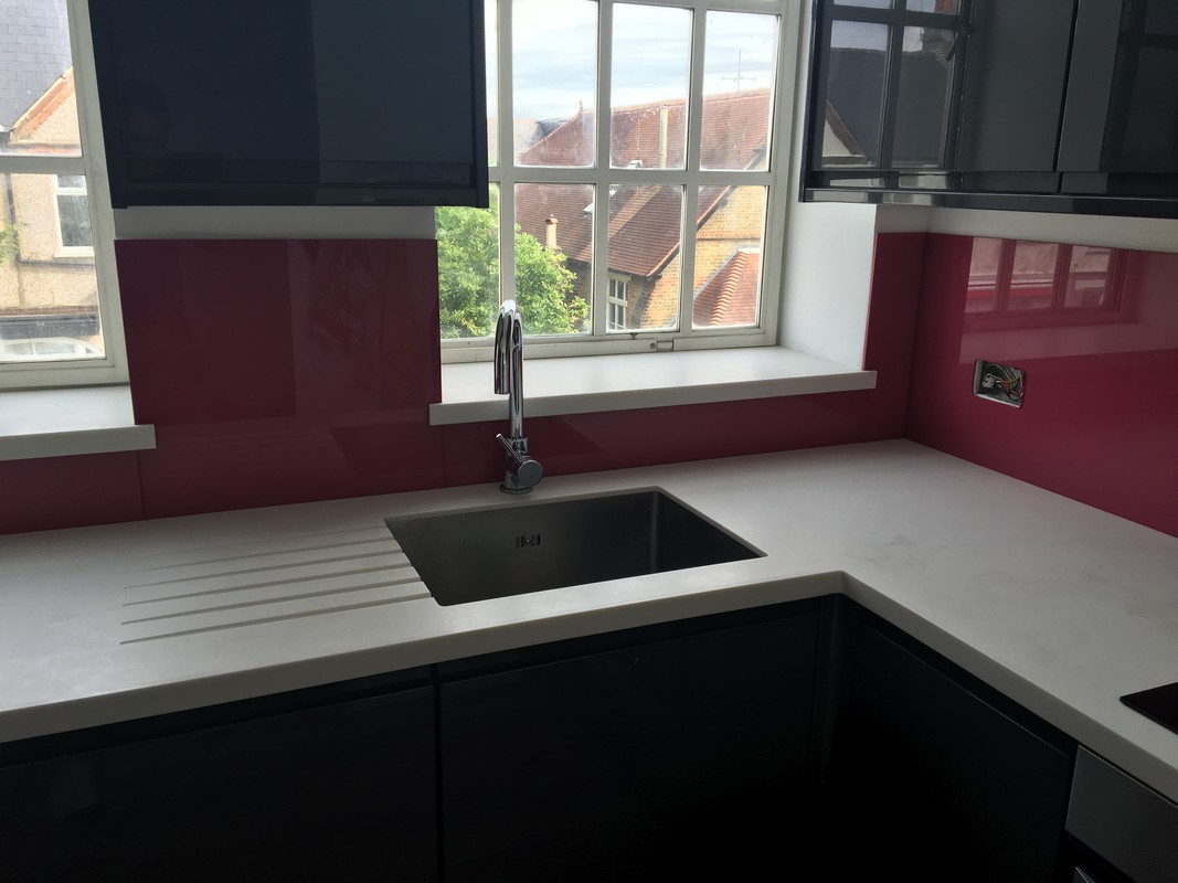 Deep plum coloured glass splashback in modern Tufnell Park kitchen